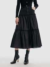 A lady wears a denim maxi skirt.